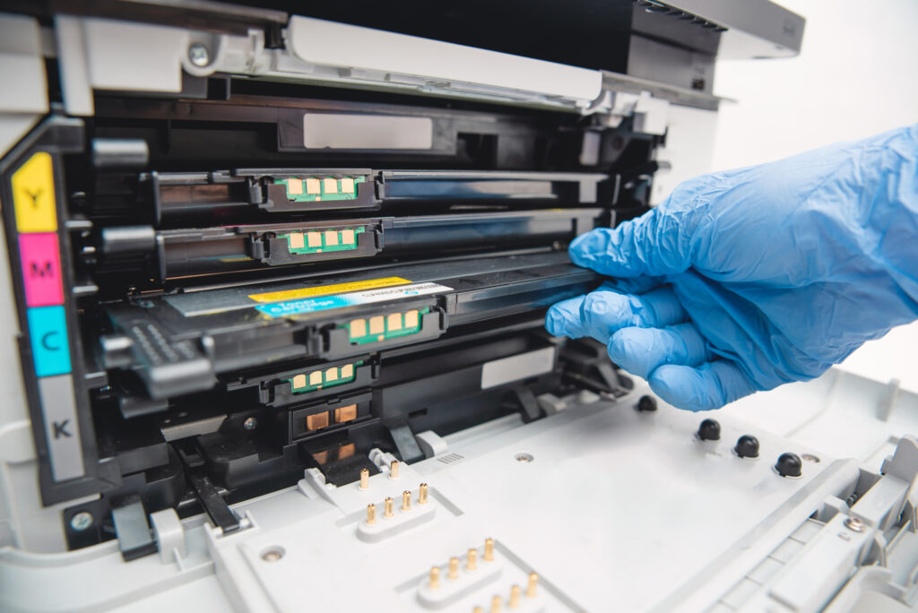 Man replacing toner in laser printer